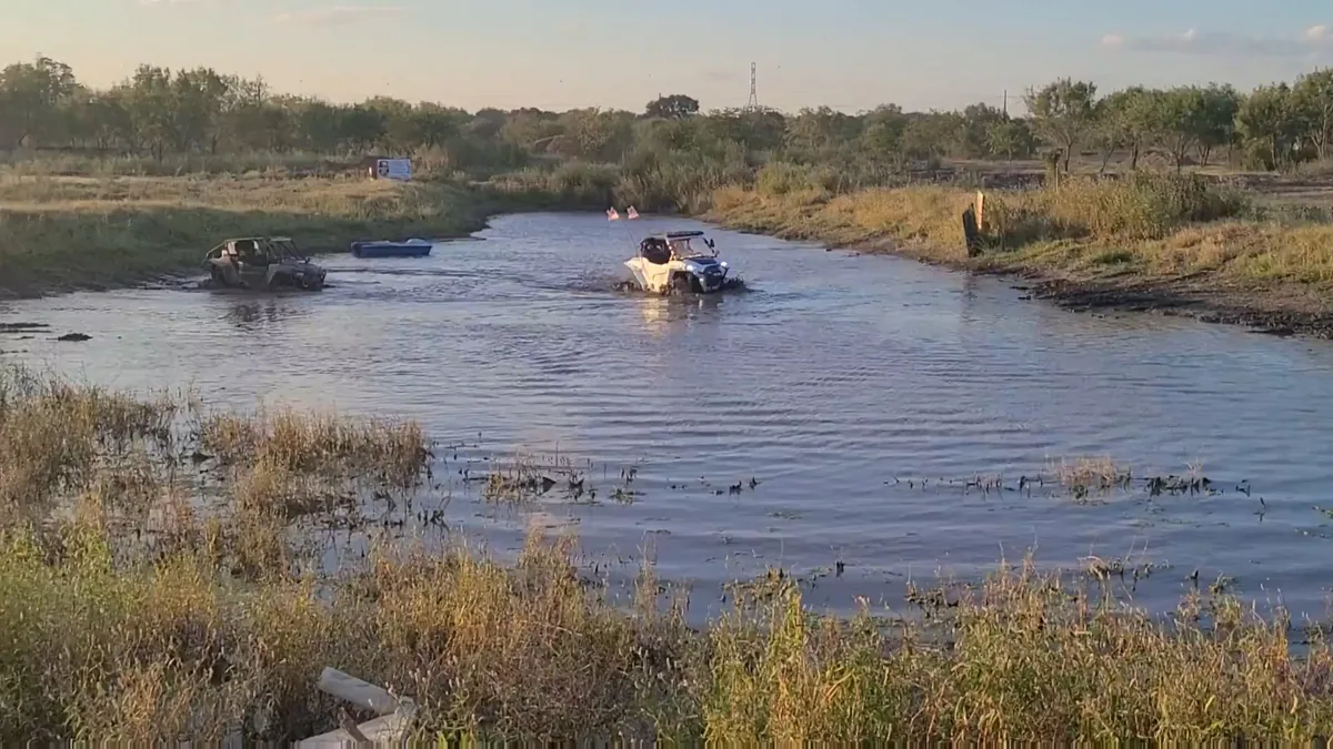 Vehicles at 281CC pond at golden hour — ATV camping sunset